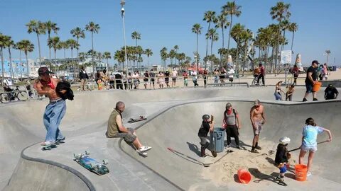 Skateboarders remove sand from iconic Venice Beach skate par