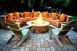 semi circle seating with round firepit and orange cushions O