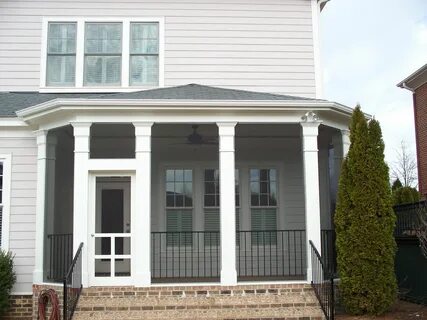 Hip style roof screened in porch with decorative columns and