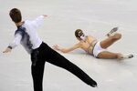 Figure skater looks on as his partner falls to the ice at Va