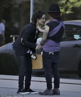 Sara Gilbert goes gaga for her baby with wife Linda Perry in