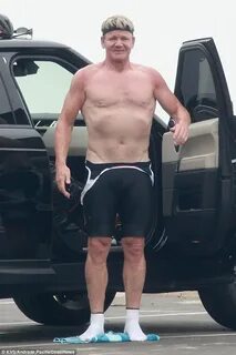 Shirtless Gordon Ramsay shows off his muscles as he strips o