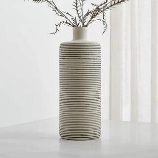 Shop Raya Cream Bottle Vase. Casual, pencil-thin lines encir