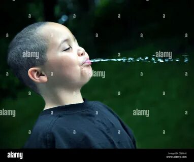 Boy spitting water hi-res stock photography and images - Ala