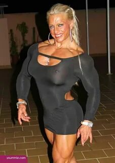 Powerful muscular blonde in little black dress Muscular wome