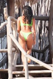 Vanessa Morgan in a tight green bikini showing nice cleavage