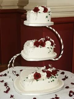 Two tier heart shaped wedding cake on 'C' stand de