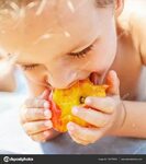 Boy eating a peach Stock Photo by © gorov108 139179292