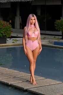 demi rose poses in a pink latex bikini during a photoshoot i