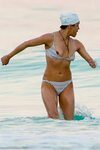 Michelle Rodriguez slips from her tiny striped bikini at the
