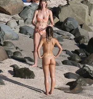 Alexis Ren caught topless in a red string bikini bottom at t
