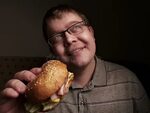 Lonely Fat Guy Eating Hamburger. Bad Eating Habits. Closeup.
