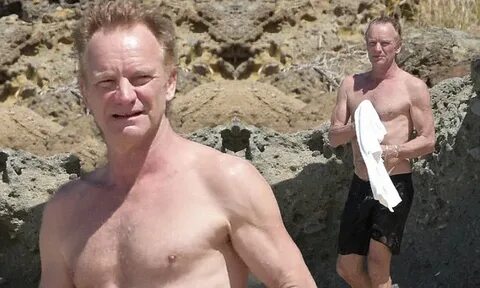 Topless Sting displays chest in the sea on St Barts beach br