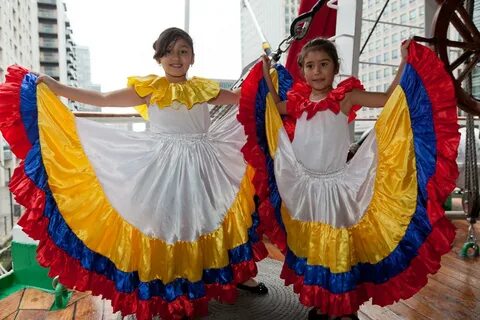 Two young girl dancers display their traditional Colombian. 