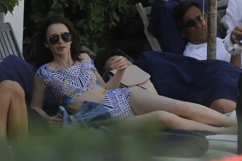 lily collins in a bikini spotted relaxing by the beach in is