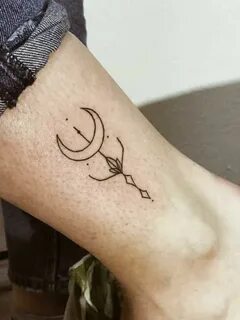 A tiny crescent moon and arrow tattoo inked on the right cal