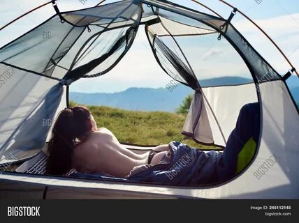 Download high-quality Back view sporty naked woman tourist lying tent image...