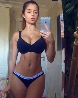 Demi Rose Mawby taking a selfie of her amazing hourglass figure.