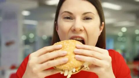 very hungry girl eating hamburger on: стоковое видео (без ли