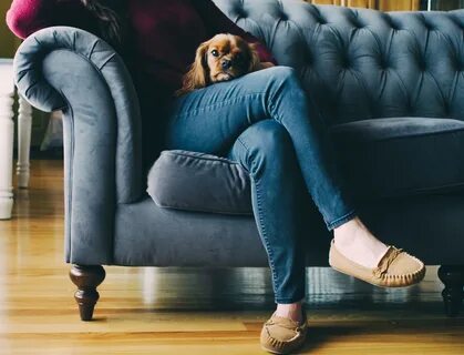 Woman sitting on the couch in cozy shoes free image download