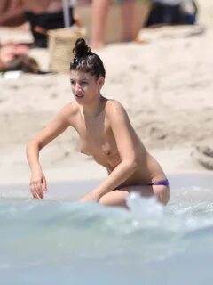 Ursula Corbero spotted topless in a purple bikini bottom at 