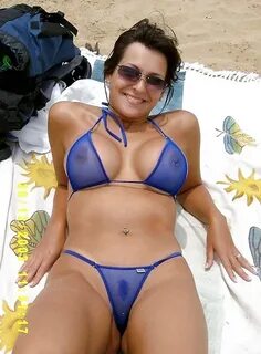 Sexy_busty_milf_in_transparent_blue_bikini_on_beach_15027048