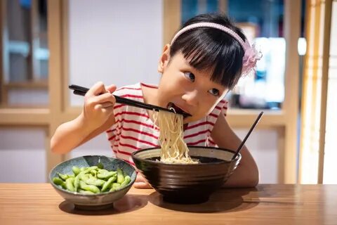 Asian girl eating eggs