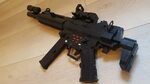 H&K MP5SD with light mounted on the barrel and C-MORE redd. 