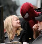 Pucker up! Emma Stone and Andrew Garfield lock lips as they 