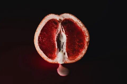 Stock image of a fruit with a red-like substance dripping out in front of a...