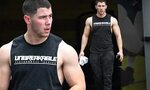 Nick Jonas flexes his big biceps in sleeveless tank after a 