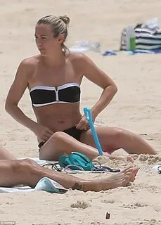 Bec Hewitt shows off her curves in a bikini during a family 