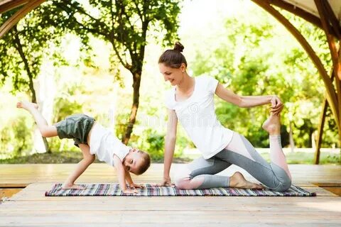 Mom and Son are Practicing Yoga in the Park. Stock Photo - I