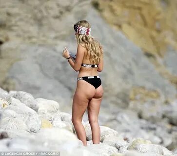 TOWIE's Amber Dowding sizzles in a slogan bikini in Ibiza Da