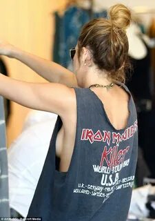 Miley Cyrus exposes side boob in a gaping Iron Maiden T-shir