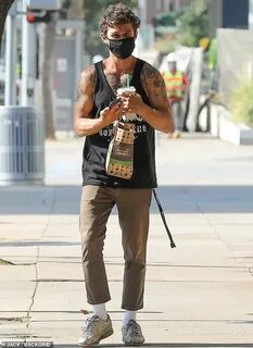 Shia LaBeouf flashes his tattooed muscles as he grabs breakf