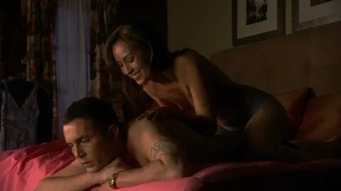 Topless Courtney Ford Massaging a Guy’s Back (Dexter Screenc