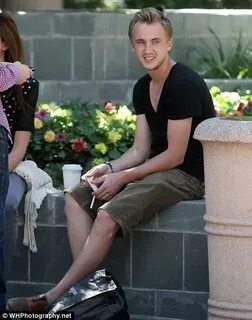 Planet of the Apes star Tom Felton enjoys a cigarette with g