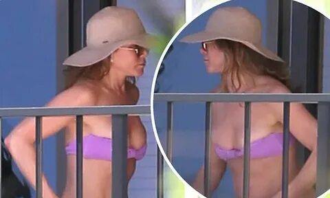 Jennifer Aniston rocks a tiny bikini while enjoying some dow
