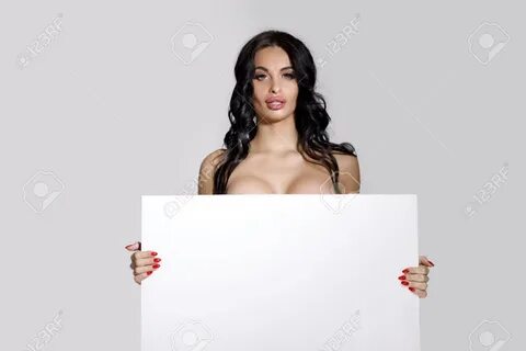 seductive naked brunette woman holding empty board. attractive sexy girl wi...