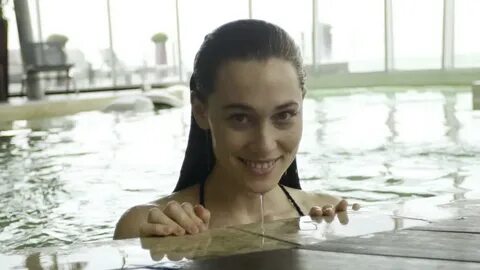 young woman emerging water pool smiling: Stockvideók (100%-b