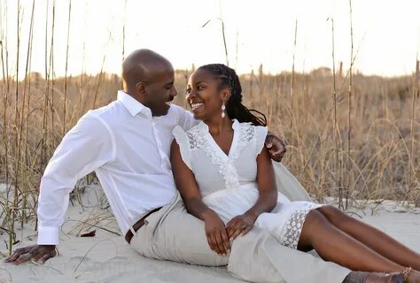 African American couple sunset engagement portrait in fron. 