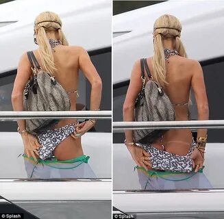 Paris Hilton reveals thong tan line as she adjusts monokini