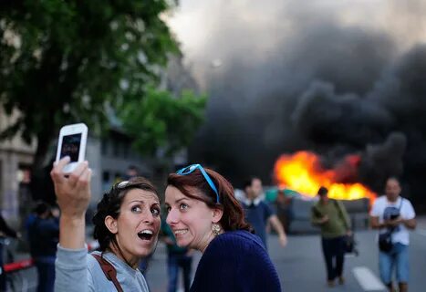 Tourists Pose for Selfie at May Day Protest Rally in Barcelo