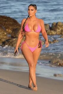 kim kardashian puts on a stunning display in a hot pink biki