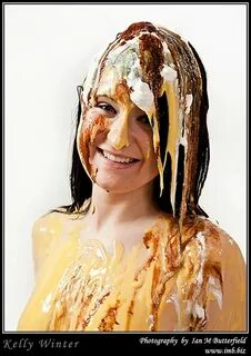 Sundae girl: A sexy young woman covered in custard, cream & 