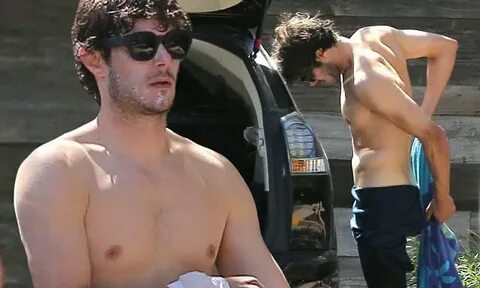 Adam Brody reveals toned torso as he publicly strips out of 