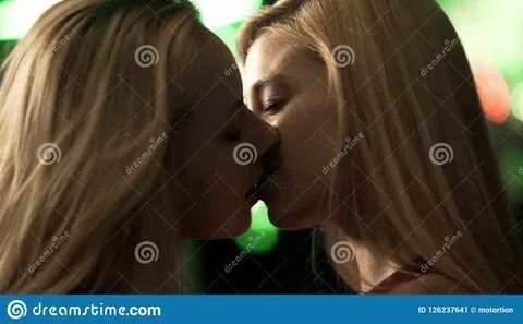 Lesbian women kiss vigorously