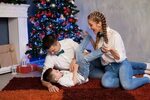 Mom Dad and Young Son at Christmas New Year Holiday Gifts St