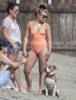 Florence Pugh In tight orange swimsuit on the beach in Malib